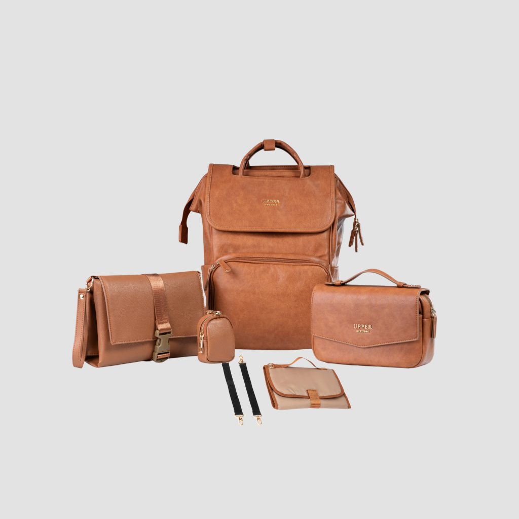 UPPER Commuter System in camel leather: backpack, crossbody bag, pouch and changing pad shown together
