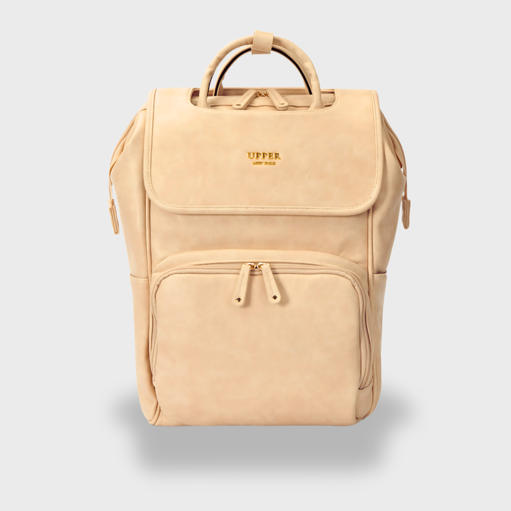 UPPER La Madison DayFlow diaper backpack in beige vegan leather, a structured bag with a top carry handle