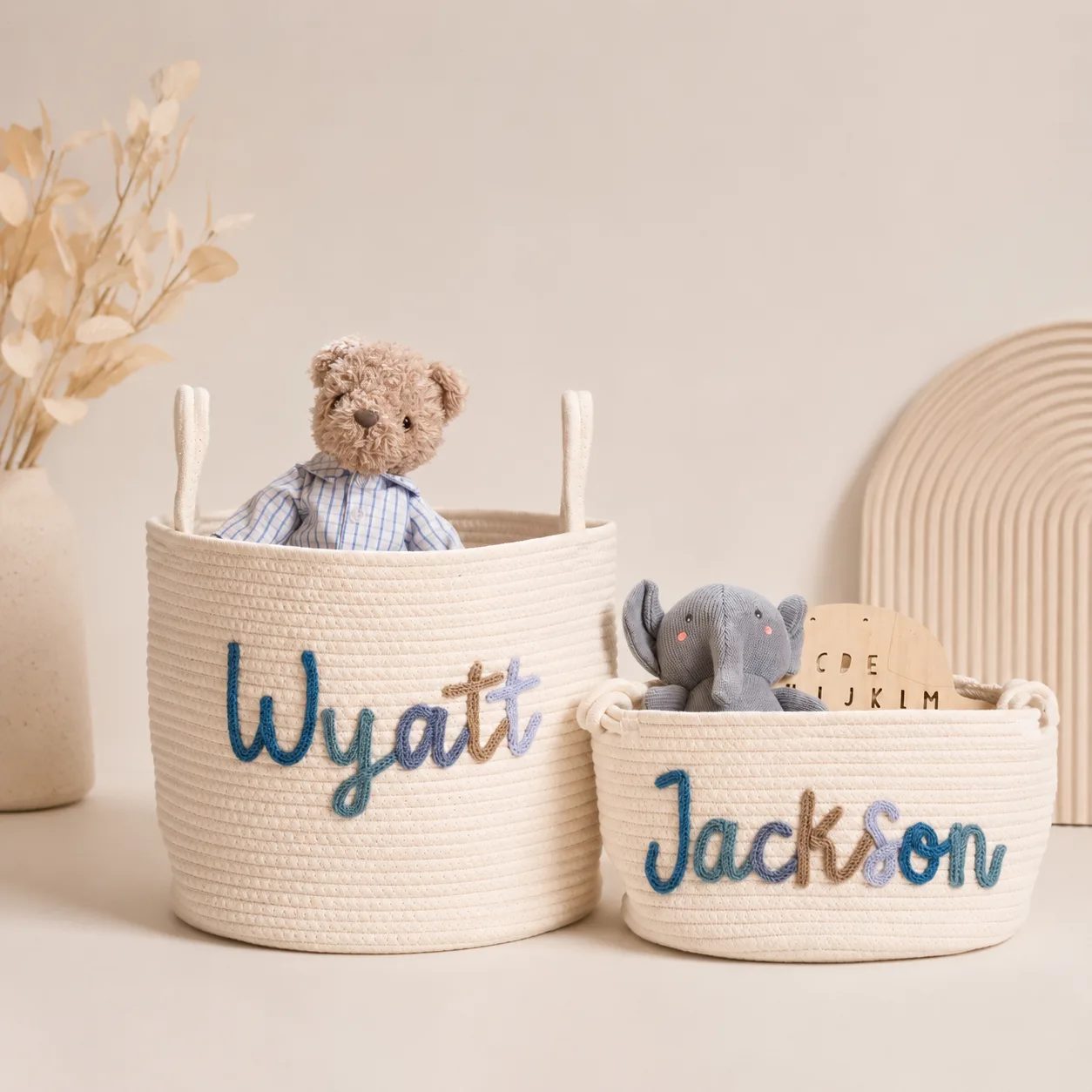 Two personalized baby gift baskets embroidered with names