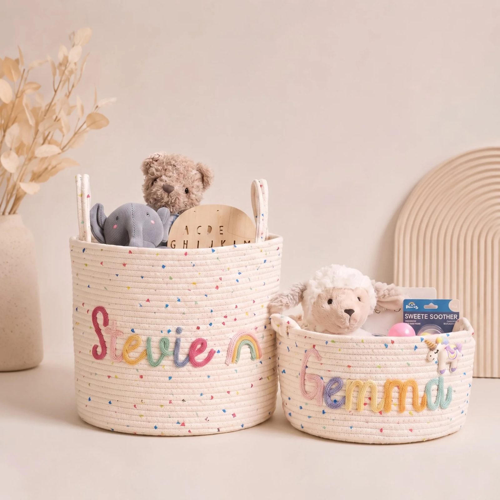 Two personalized nursery storage baskets with colorful names