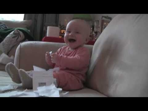 Baby laughing hysterically at ripping paper