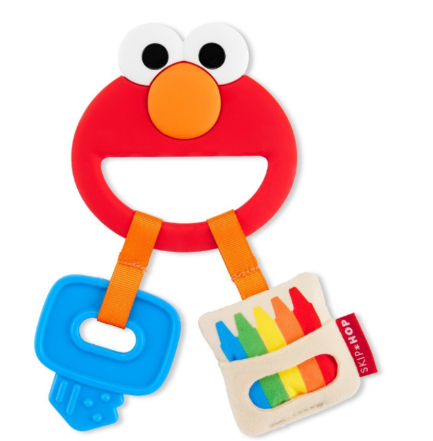 Recalled Skip Hop Baby Sesame Street Elmo Silicone Teether: red Elmo face with black pupils, attached to a blue textured key and a fabric crayon box with a red Skip Hop tag